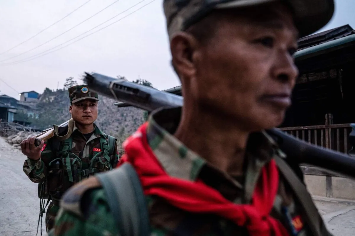 Members of ethnic rebel group Ta'ang National Liberation Army (TNLA) patrol near Namhsan Township in Myanmar's northern Shan State In this photo taken on March 9, 2023. (STR/AFP via Getty Images)