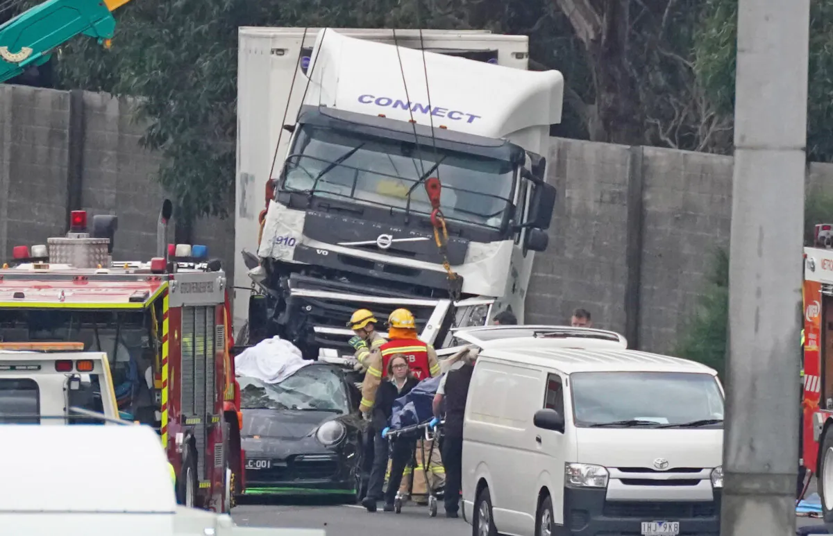 Emergency services respond to a collision near the Chandler Highway in the suburb of Kew in Melbourne, April 23, 2020. Four police officers have died in a horror crash involving a truck on Melbourne's Eastern Freeway, with the Major Collision Investigation Unit at the scene. (AAP Image/Scott Barbour)
