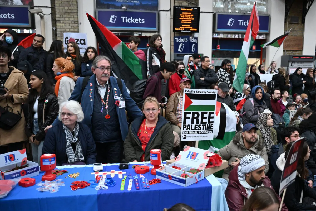 Fundraisers for the Royal British Legion selling poppies find themselves surrounded by protesters in central London on Nov. 4, 2023. (Justin Tallis/AFP via Getty Images)