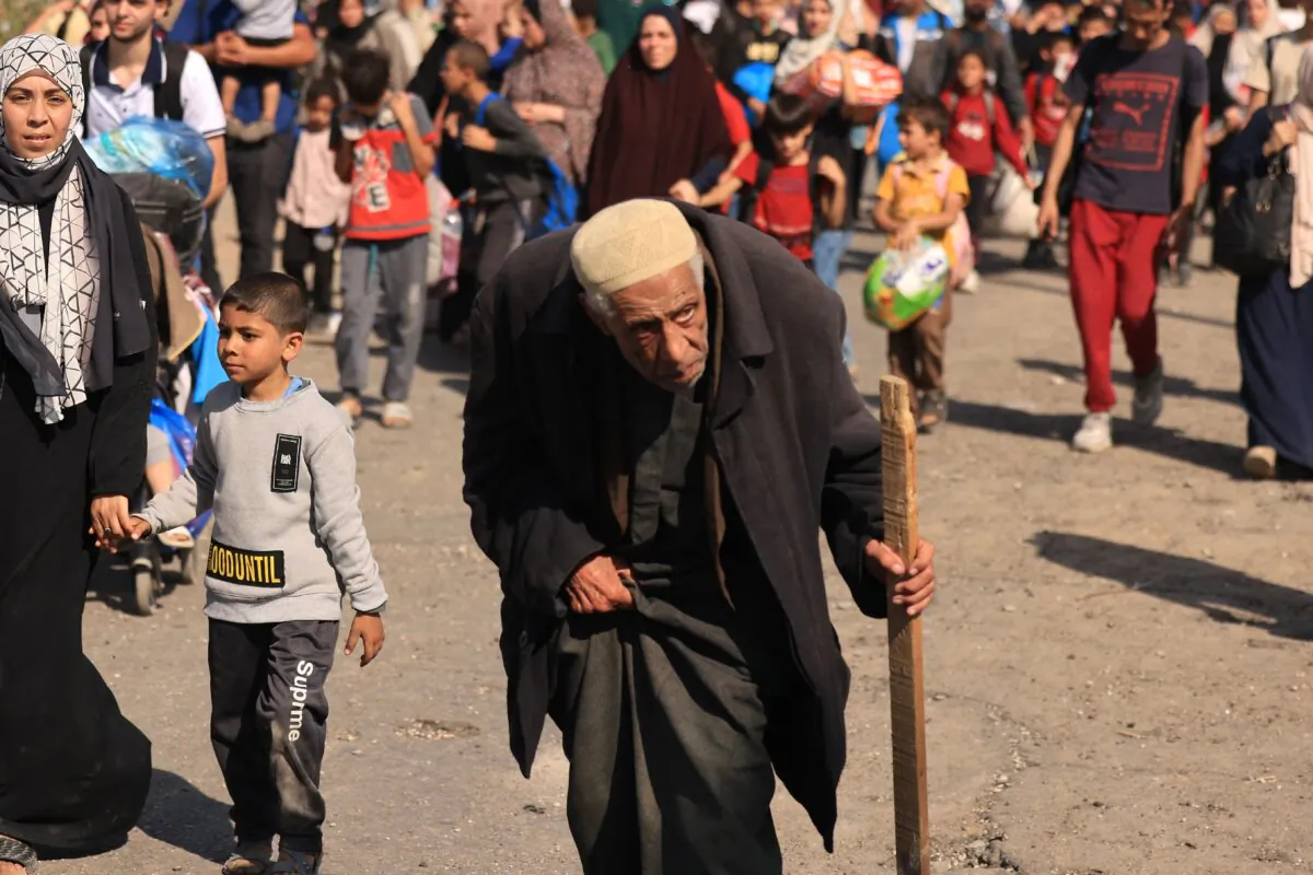 Palestinians families fleeing Gaza City and other parts of northern Gaza towards the southern areas, walk along a road on Nov. 10, 2023. (Mahmud Hams/AFP via Getty Images)