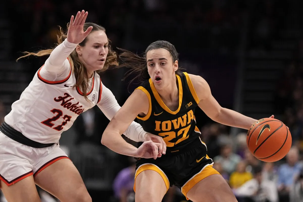 Iowa guard Caitlin Clark (R) drives to the basket past Virginia Tech guard Cayla King during the first half of an NCAA women's college basketball game in Charlotte, N.C., on Nov. 9, 2023. (Chris Carlson/AP Photo)