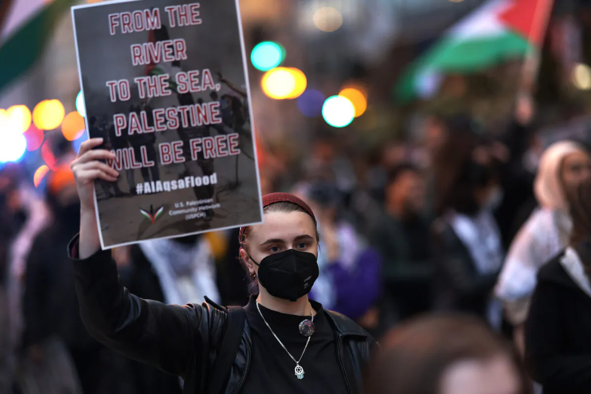 A demonstrator holds a sign reading '"From the river to the sea, Palestine will be free" at a pro-Palestinian rally in Chicago, Illinois, on Oct. 11, 2023. (Scott Olson/Getty Images)