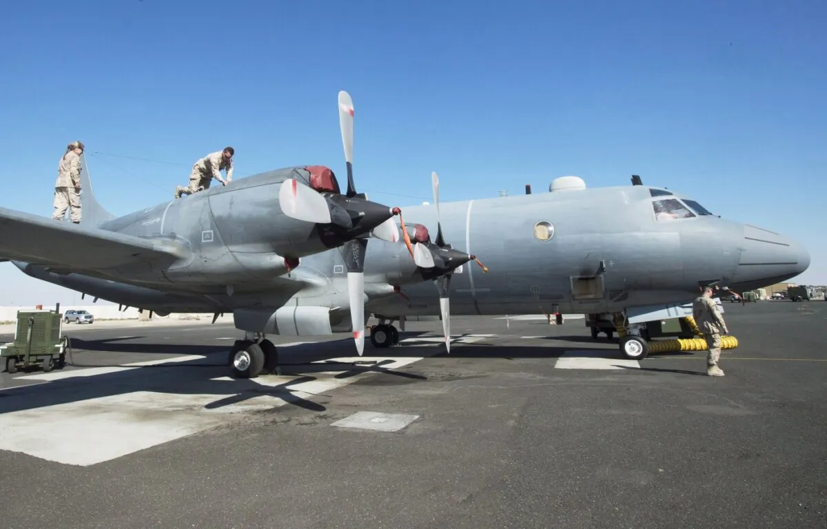 Members of the Canadian Forces work on a CP140 Aurora surveillance plane at the Canadian Forces base in the Persian Gulf on Feb. 19, 2017. (The Canadian Press/Ryan Remiorz)