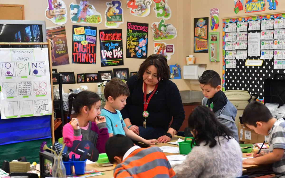 An elementary school teacher works with her students in Pacoima, Calif., on Feb. 8, 2019. (Frederic J. Brown/AFP via Getty Images)