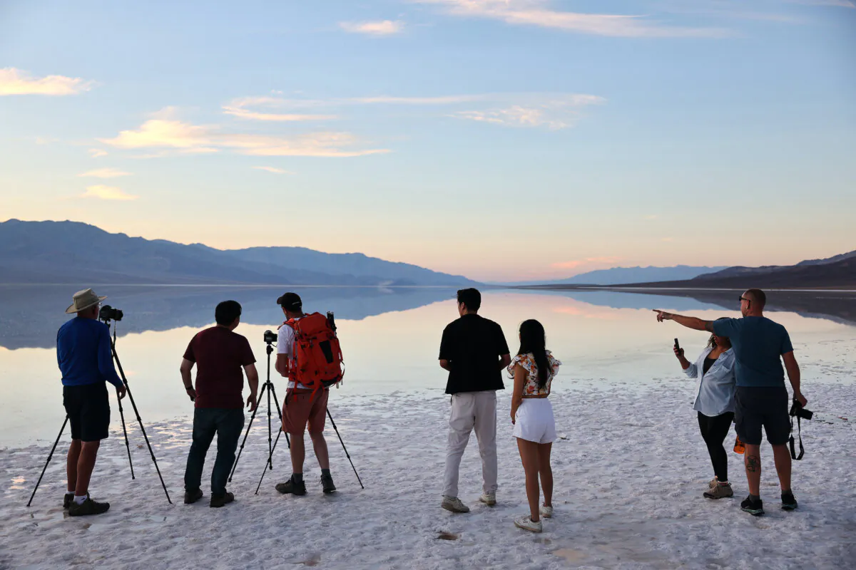 Visitors gather and take photos at a temporary lake at Badwater Basin salt flats, caused by flooding in August from Tropical Storm Hilary, in Death Valley National Park, Calif., on Oct. 21, 2023. (Mario Tama/Getty Images)