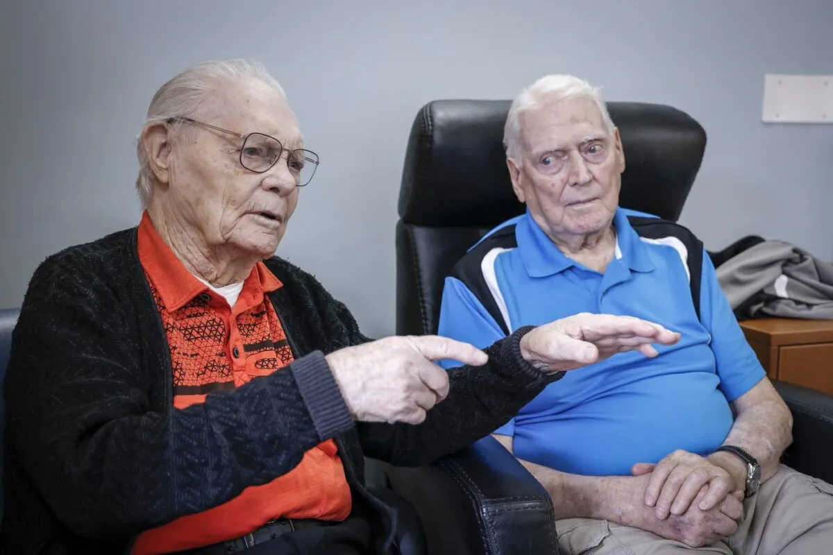 Royal Canadian Air Force veteran Bill Cook, left, describes his first combat mission as fellow veteran Hank Jackson, 102, looks on in Calgary, Nov. 7, 2023. (The Canadian Press/Jeff McIntosh)
