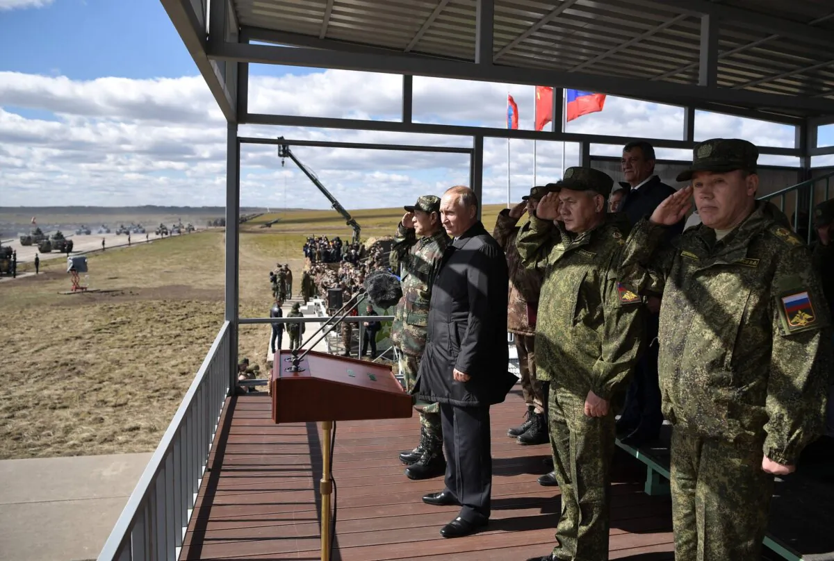Russia's President Vladimir Putin (2L), China's Defense Minister Wei Fenghe (L), Russian Defence Minister Sergei Shoigu (3R) and Chief of the General Staff of the Russian Armed Forces Valery Gerasimov (R) watch the parade of the participants of the Vostok-2018 (East-2018) military drills at Tsugol training ground not far from the Chinese and Mongolian border in Siberia, on September 13, 2018. (ALEXEY NIKOLSKY/AFP via Getty Images)