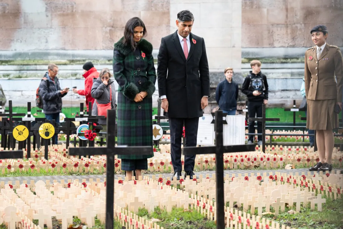 Prime Minister Rishi Sunak and his wife Akshata Murty observe the Remembrance Crosses during a visit to the Field of Remembrance, in its 95th year, at Westminster Abbey in London on Nov. 10, 2023. (Stefan Rousseau/PA)