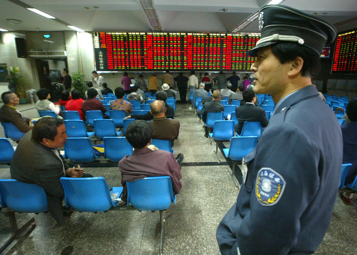A security man stands in a local securities in Shanghai, China, on April 30, 2004. (Liu Jin/AFP via Getty Images)