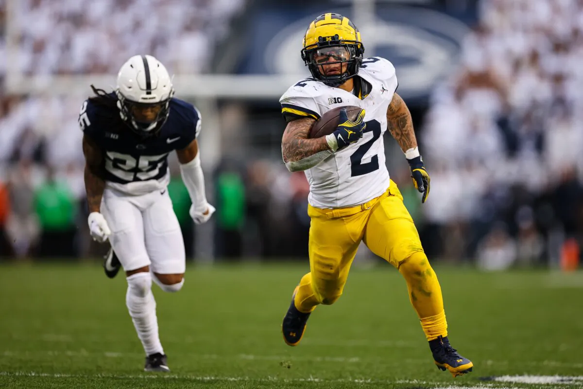 Blake Corum (2) of the Michigan Wolverines runs for a touchdown in front of Daequan Hardy (25) of the Penn State Nittany Lions during the second half at Beaver Stadium in State College, Penn., on Nov. 11, 2023. (Scott Taetsch/Getty Images)