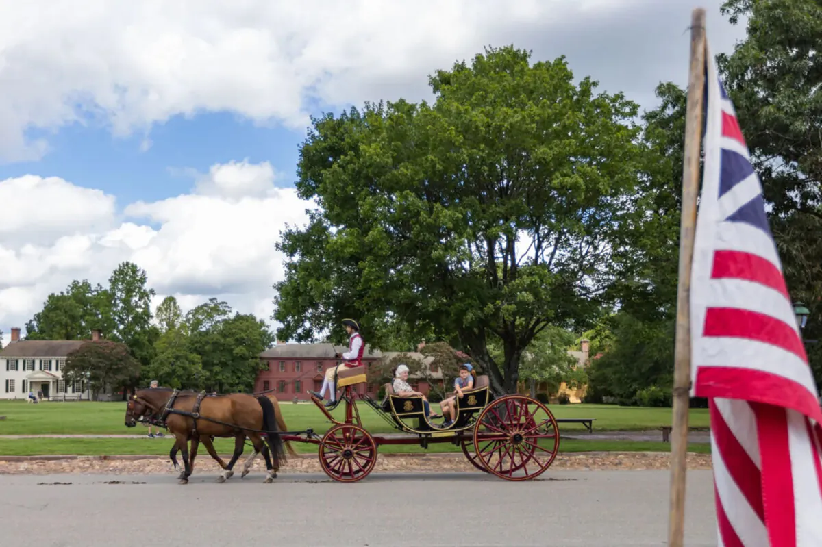 Visitors enjoy a horse-drawn carriage ride in Colonial Williamsburg in Williamsburg, Virginia, on Aug. 8, 2023. (Tess Crowley/The Virginian-Pilot/TNS)