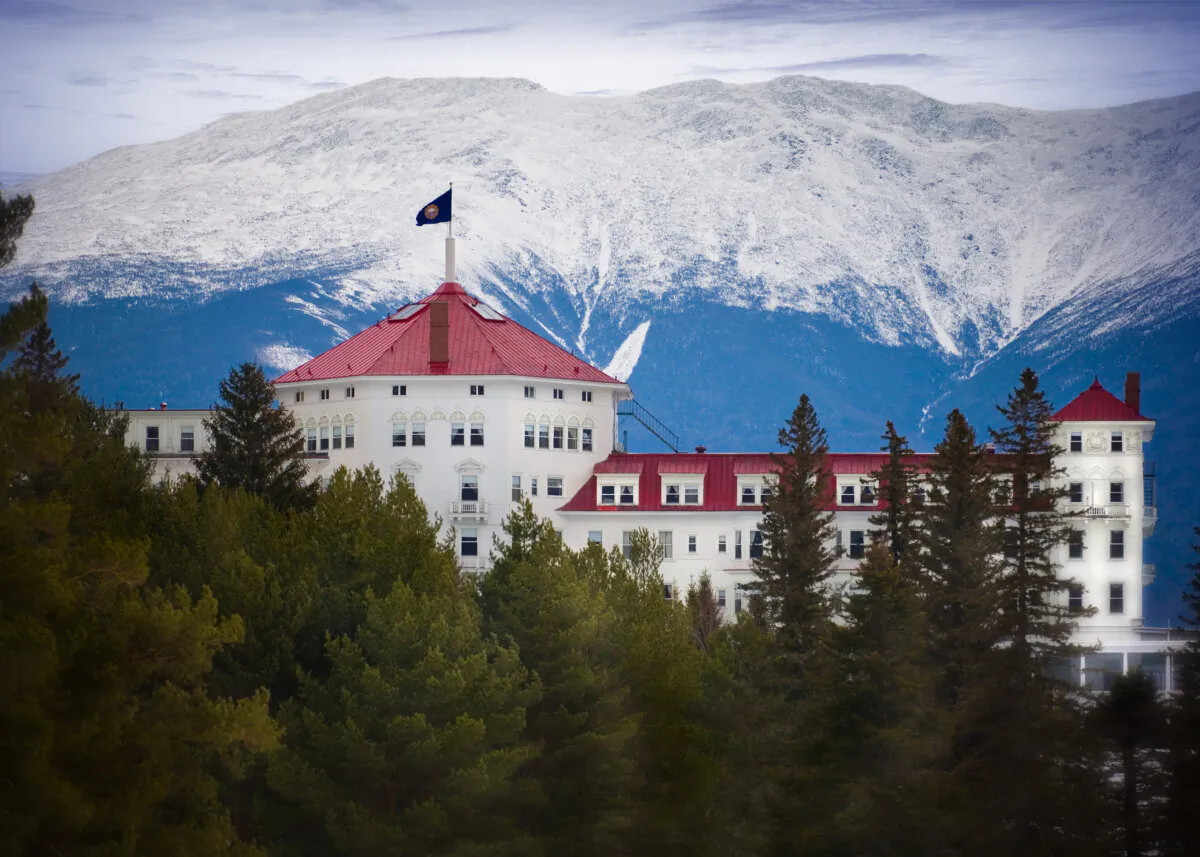 Looming near the original structure of the hotel is the Presidential Mountain Range, part of the Appalachian Mountains. Mount Washington is the highest peak in the range that includes Mounts Jefferson, Adams, Monroe, and Madison. Prominent in this exterior view is the main turret, one of three, and its red standing-seam, metal roof. The New Hampshire state flag flies at the tower’s top. Two dozen Juliette balconies, a balustrade connection to the building façade without a deck to walk on, serve more as decoration than for practical enjoyment. (Courtesy of the Mount Washington Hotel)