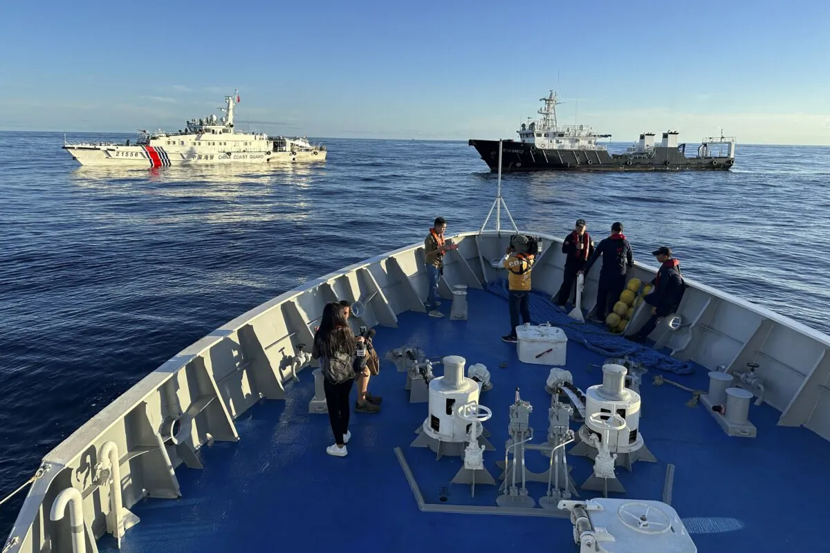 Chinese coast guard and suspected Chinese militia ship block the Philippine coast guard ship BRP Cabra as they approach Second Thomas Shoal, locally known as Ayungin Shoal, during a resupply mission at the disputed South China Sea on Nov. 10, 2023. (Joeal Calupitan/AP Photo)