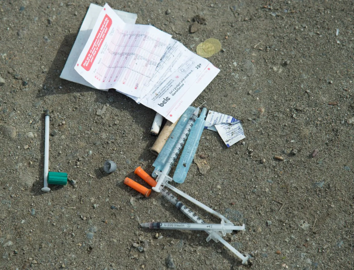 Needles are seen on the ground in Oppenheimer park in Vancouver's Downtown Eastside in a file photo. (The Canadian Press/Jonathan Hayward)