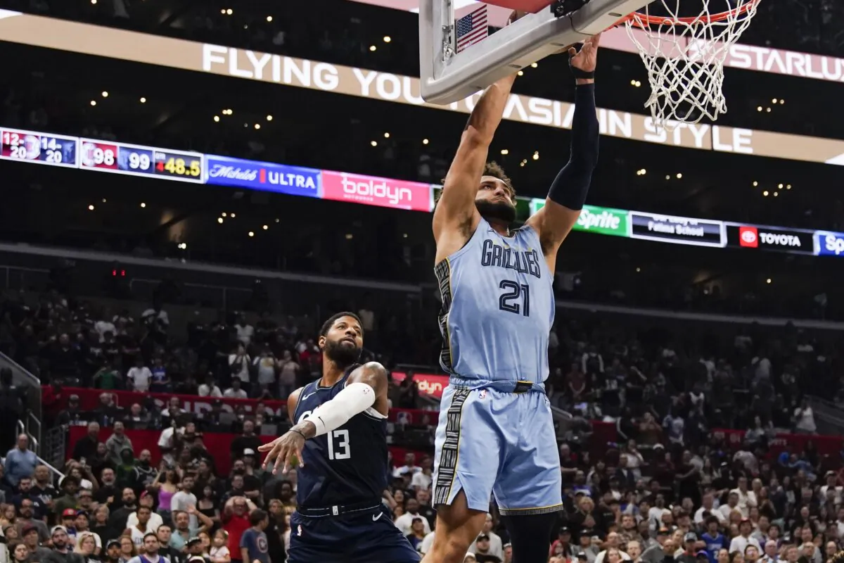 Memphis Grizzlies forward David Roddy (R) shoots the ball past Los Angeles Clippers forward Paul George during the second half of an NBA basketball game in Los Angeles on Nov. 12, 2023. (Ryan Sun/AP Photo)