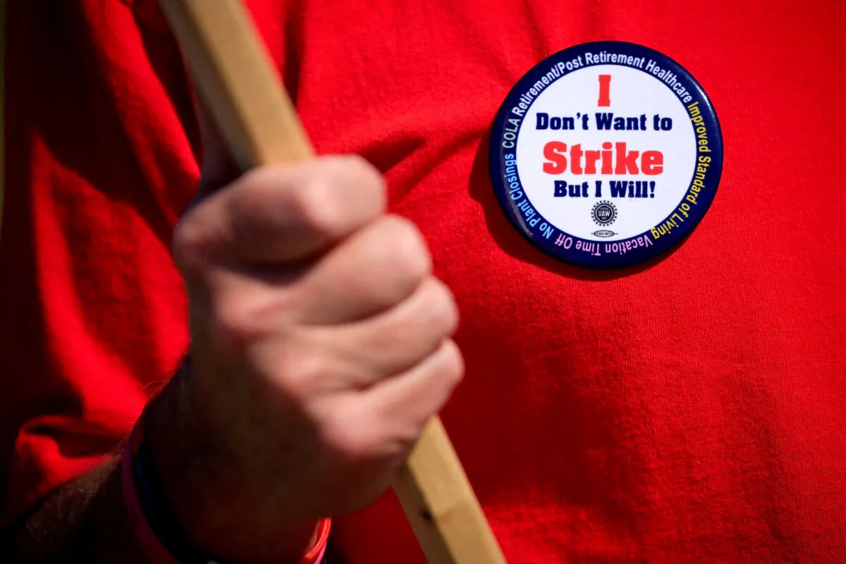 A United Auto Workers (UAW) union member wears a pin while picketing outside Ford's Kentucky truck plant after going on strike in Louisville, Ky., on Oct. 12, 2023. (Luke Sharrett/Reuters)