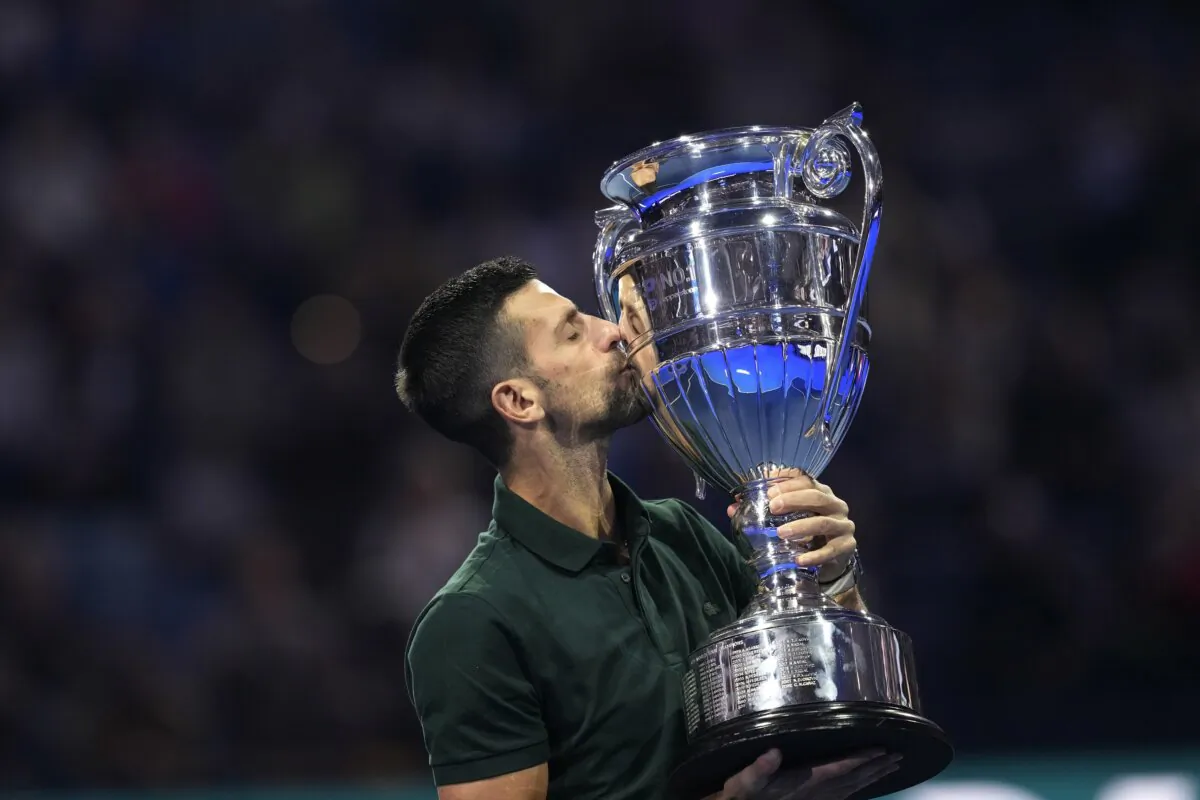 Serbia's Novak Djokovic kisses the trophy as ATP world best player at the ATP World Tour Finals, at the Pala Alpitour in Turin, Italy, on Nov. 13, 2023. (Antonio Calanni/AP Photo)
