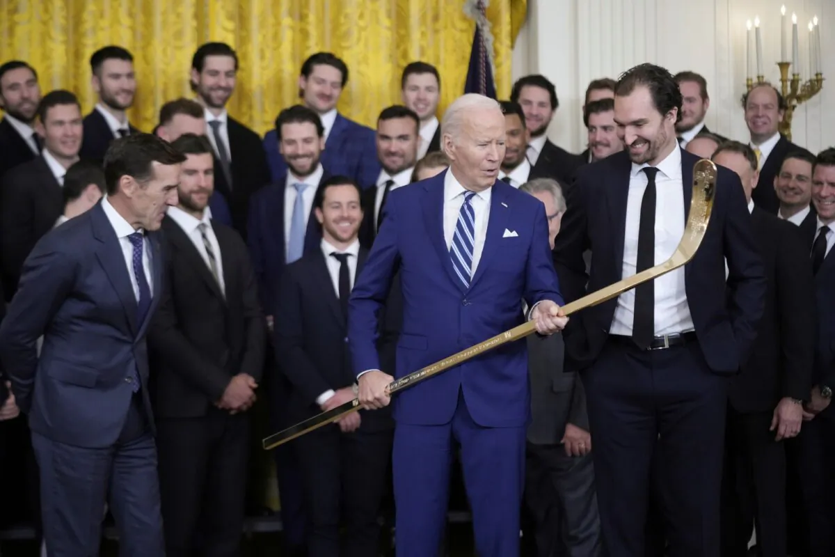 President Joe Biden looks over a hockey stick with team captain Mark Stone, during an event to celebrate the Vegas Golden Knights in their 2023 Stanley Cup victory in the East Room of the White House, in Washington on Nov. 13, 2023. (Andrew Harnik/AP)