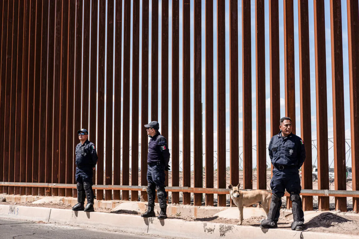 Mexico's federal police stand guard at the U.S.-Mexico border fence as U.S. President Donald Trump visits Calexico, California, as seen from Mexicali, Baja California state, Mexico, on April 5, 2019. (Guillermo Arias/AFP via Getty Images)