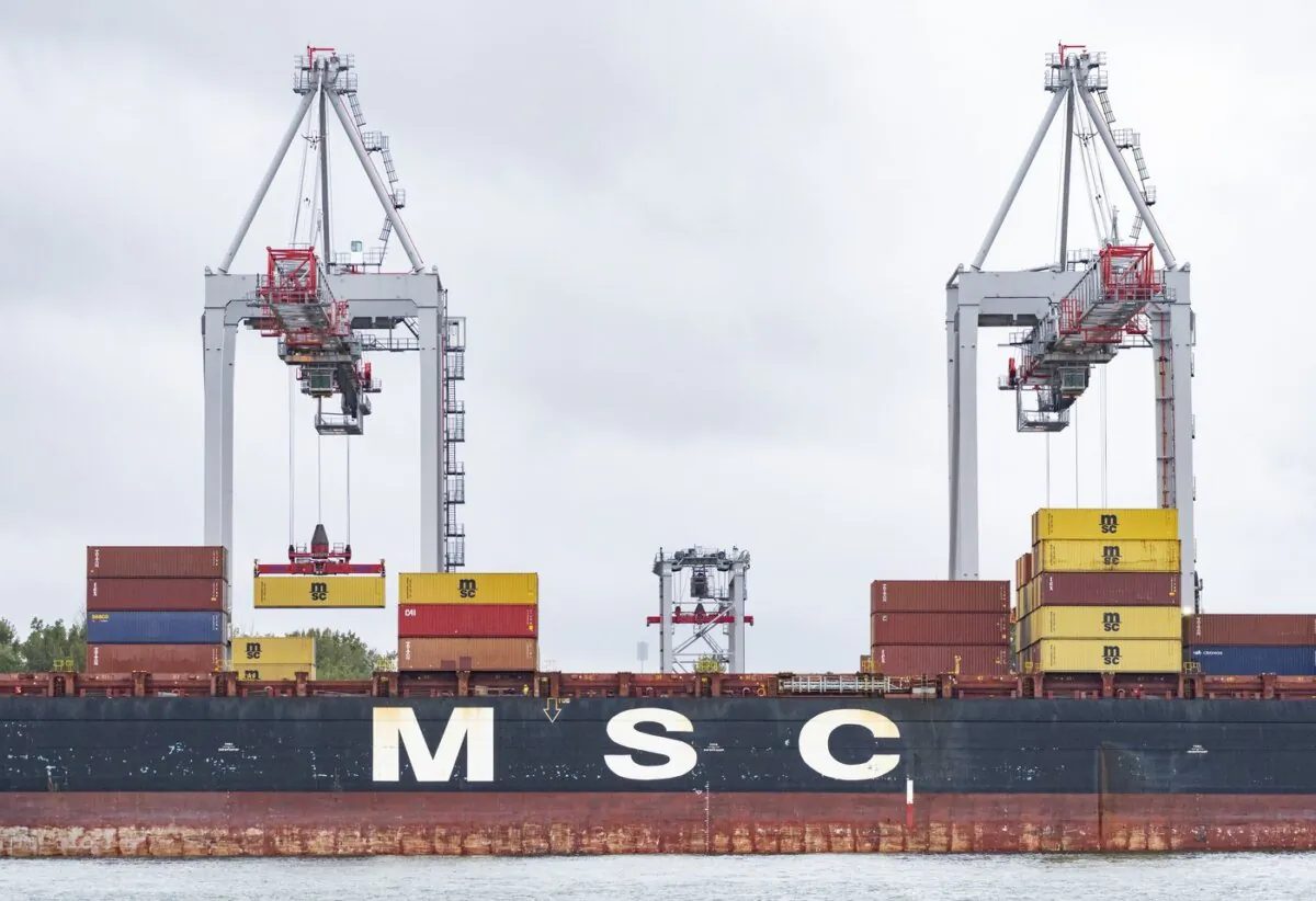 A shipping container is loaded onto a container ship in the Port of Montreal, on Sept.19, 2023. (The Canadian Press/Christinne Muschi)