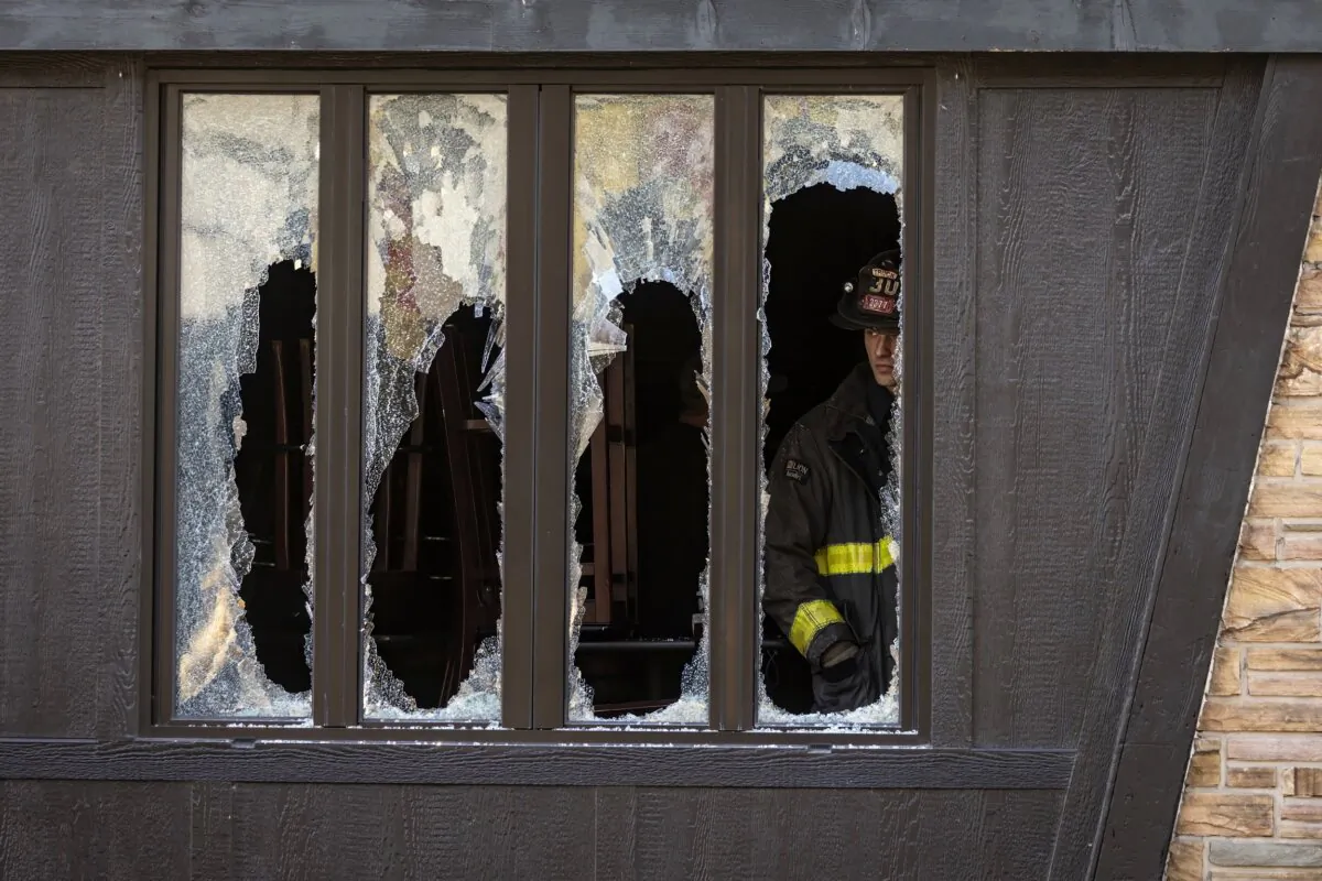 Chicago Fire Department personnel investigate after an early morning blaze in Chicago on Nov. 13, 2023. (Ashlee Rezin/Chicago Sun-Times via AP)