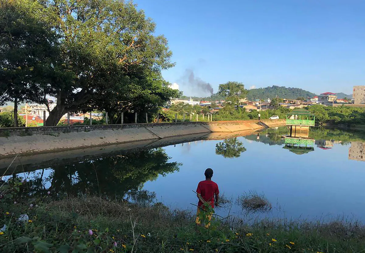 A man watching smoke rising from the direction of a Burma military base in Lashio township, northern Shan State on Nov. 7, 2023. Almost 50,000 people have been displaced by fighting in northern Burma after an alliance of ethnic armed groups launched an offensive against the military two weeks ago, the United Nations said on Nov. 10. (STR/AFP via Getty Images)