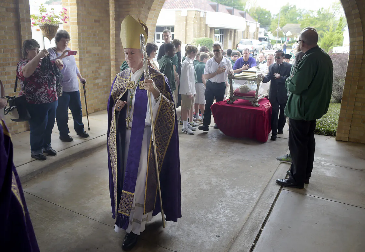 Bishop Joseph Strickland walks in front of a reliquary bearing the bones of Saint Maria Goretti, dubbed "The Little Saint of Great Mercy," into the sanctuary at Cathedral of the Immaculate Conception in Tyler, Texas, on Nov. 2, 2015. (Andrew D. Brosig/Tyler Morning Telegraph via AP)