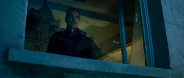 man looking out window in THE KILLER