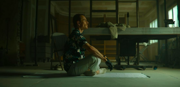 man sits on a mat on the floor in THE KILLER