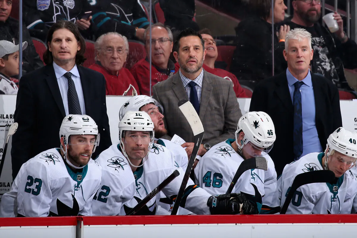 Coaches (top L-R) Mike Ricci, head coach Bob Boughner, and Roy Sommer of the San Jose Sharks watch from the bench during the third period of the NHL game against the Arizona Coyotes at Gila River Arena in Glendale, Arizona, on January 14, 2020. (Christian Petersen/Getty Images)