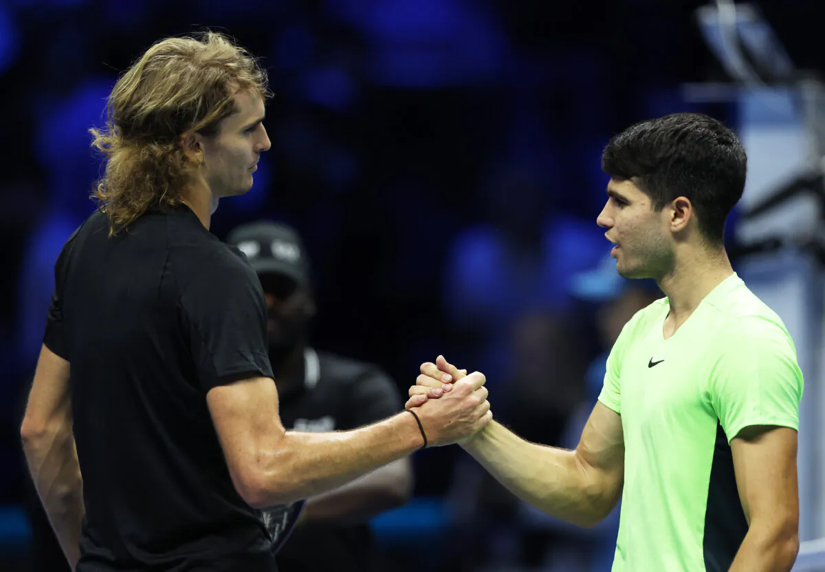 Alexander Zverev of Germany shakes hands at the net after his three set victory against Carlos Alcaraz of Spain during the Round Robin match on day two of the Nitto ATP Finals at Pala Alpitour in Turin, Italy, on Nov. 13, 2023. (Clive Brunskill/Getty Images)