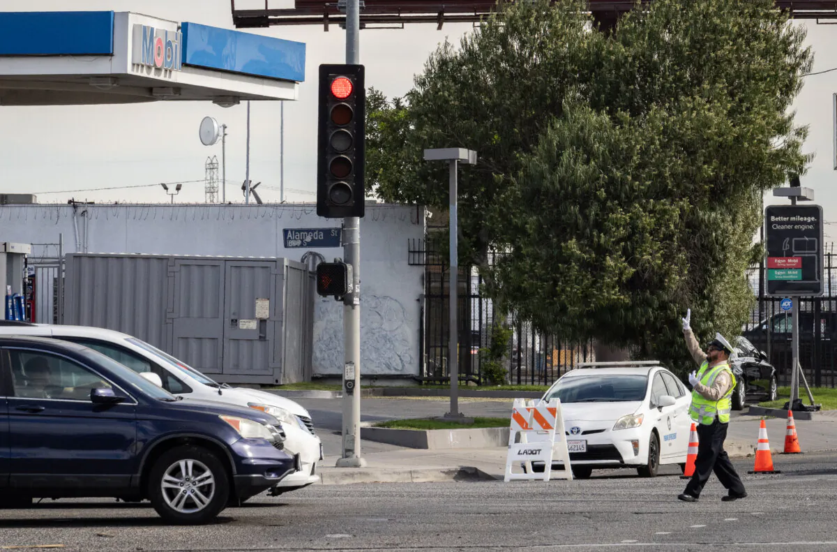 A traffic officer directs traffic in Los Angeles, Calif., on Nov. 13, 2023. (John Fredricks/The Epoch Times)