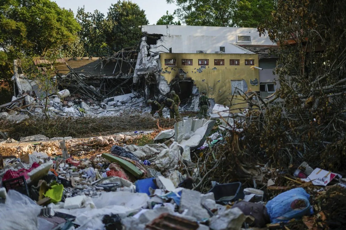 Israeli soldiers walk past houses destroyed by Hamas militants in Kibbutz Be'eri, Israel, Oct. 14, 2023. (The Canadian Press/AP, Ariel Schalit)