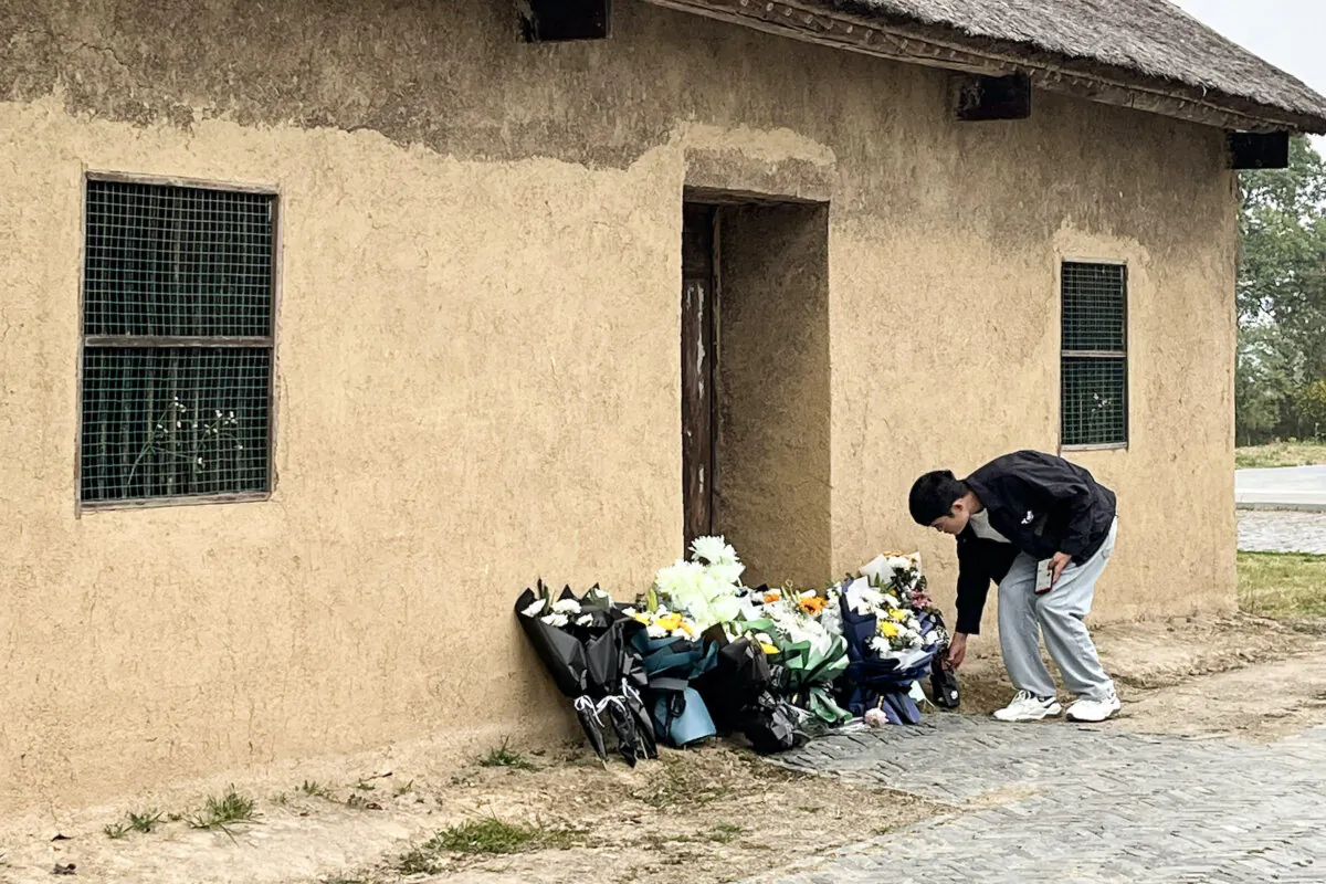 A man places flowers in front of the former house of former Chinese premier Li Keqiang in Dingyuan county, Chuzhou city, in China's eastern Anhui Province on Oct. 27, 2023. (Rebecca Bailey/AFP via Getty Images)
