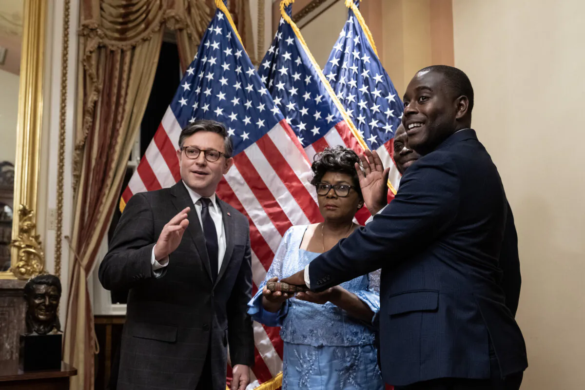 U.S. Speaker of the House Mike Johnson (R-La.) (left) participates in a ceremonial swearing in for new Rep. Gabe Amo (D-R.I.) at the Capitol in Washington on Nov. 13, 2023. (Drew Angerer/Getty Images)