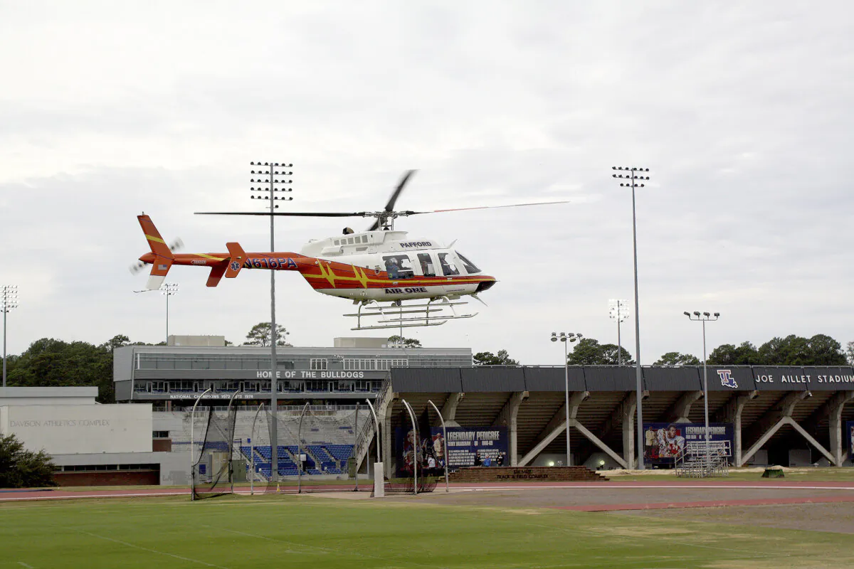 A Pafford EMS medical transport helicopter lifts off from outside Joe Aillet Stadium on the Louisiana Tech University campus to transport a victim from a morning stabbing incident that took place at the Lambright Sports & Wellness Center, in Ruston, La., on Nov. 13, 2023. (Caleb Daniel/Ruston Daily Leader via AP)