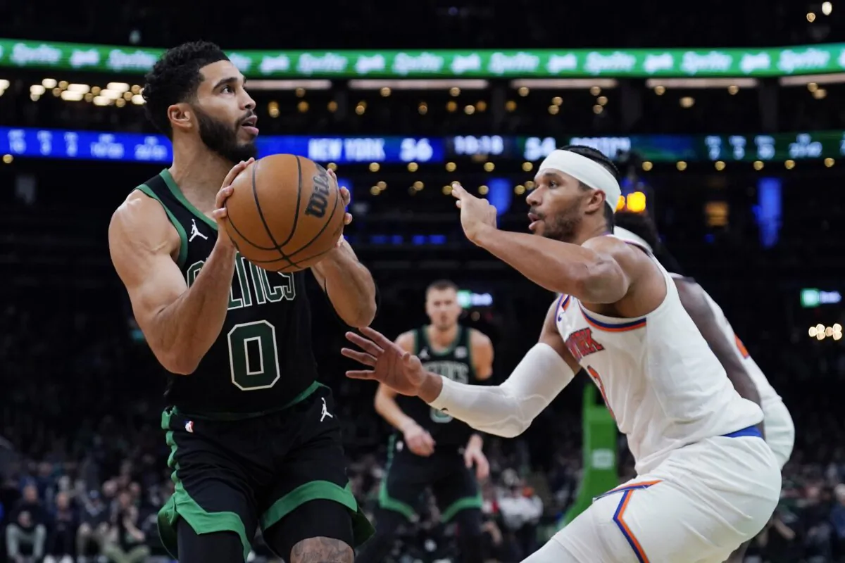 Boston Celtics forward Jayson Tatum (0) lines up a shot against New York Knicks guard Josh Hart during the second half of an NBA basketball game in in Boston on Nov. 13, 2023. (Charles Krupa/AP Photo)