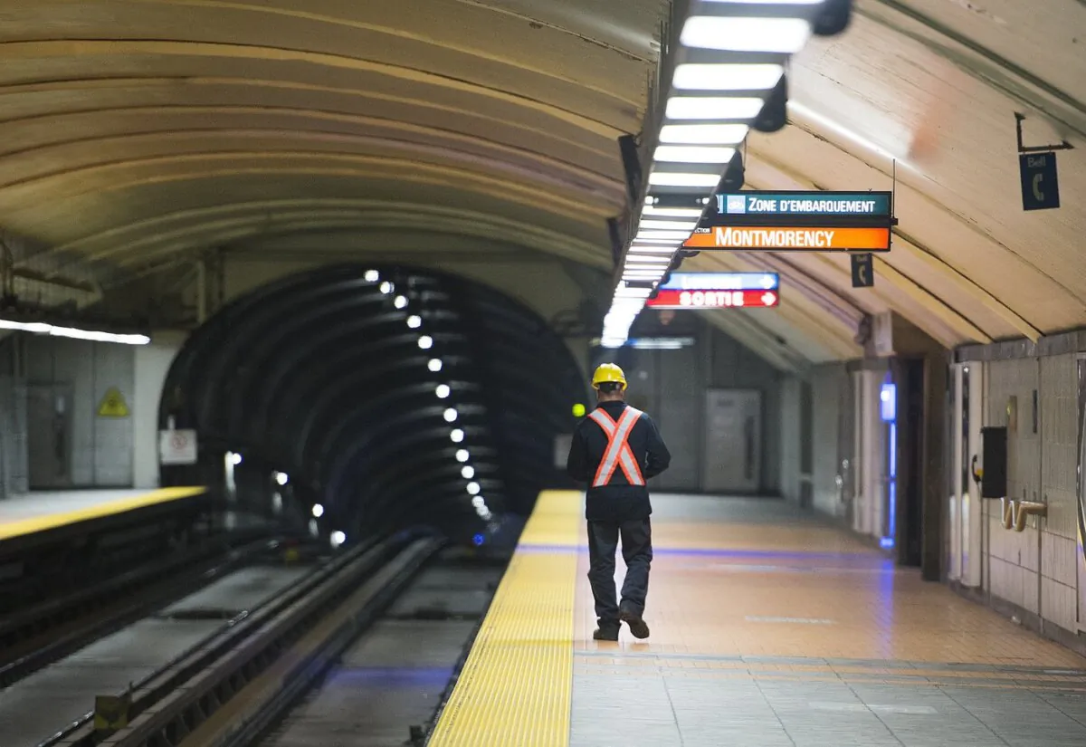 A Montreal Métro maintenance worker walks along a station platform during the early hours of the morning in Montreal, on April 11, 2019. (The Canadian Press/Graham Hughes)