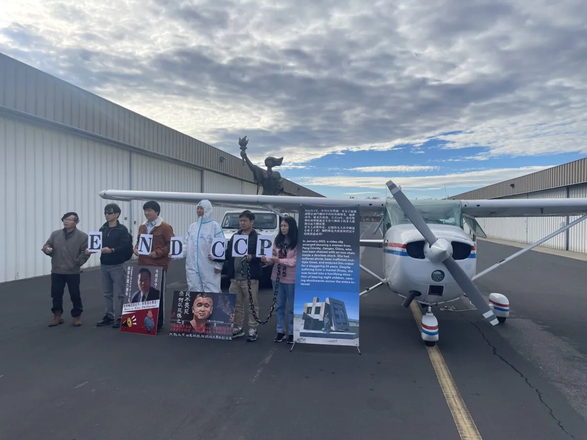 Chinese pro-democracy activists stand at the send-off event at Livermore Airport, Calif., on Nov. 14, 2023 to show their support for a pro-China freedom banner flight over San Francisco. (Nathan Su/The Epoch Times)