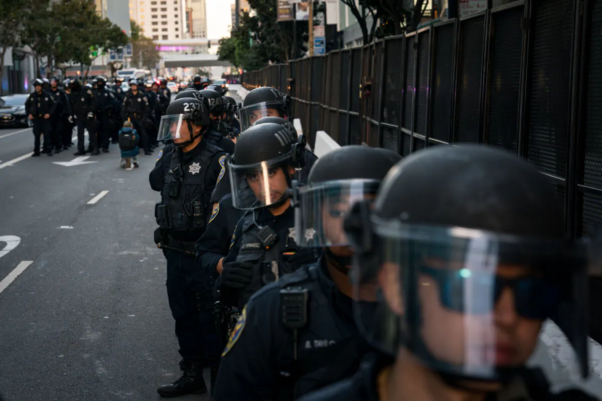 Police arrive to help escort vehicles blocked by protesters of the Asia-Pacific Economic Cooperation (APEC) global trade summit headed for the Moscone Center in San Francisco on Nov. 12, 2023. (Kent Nishimura/Getty Images)