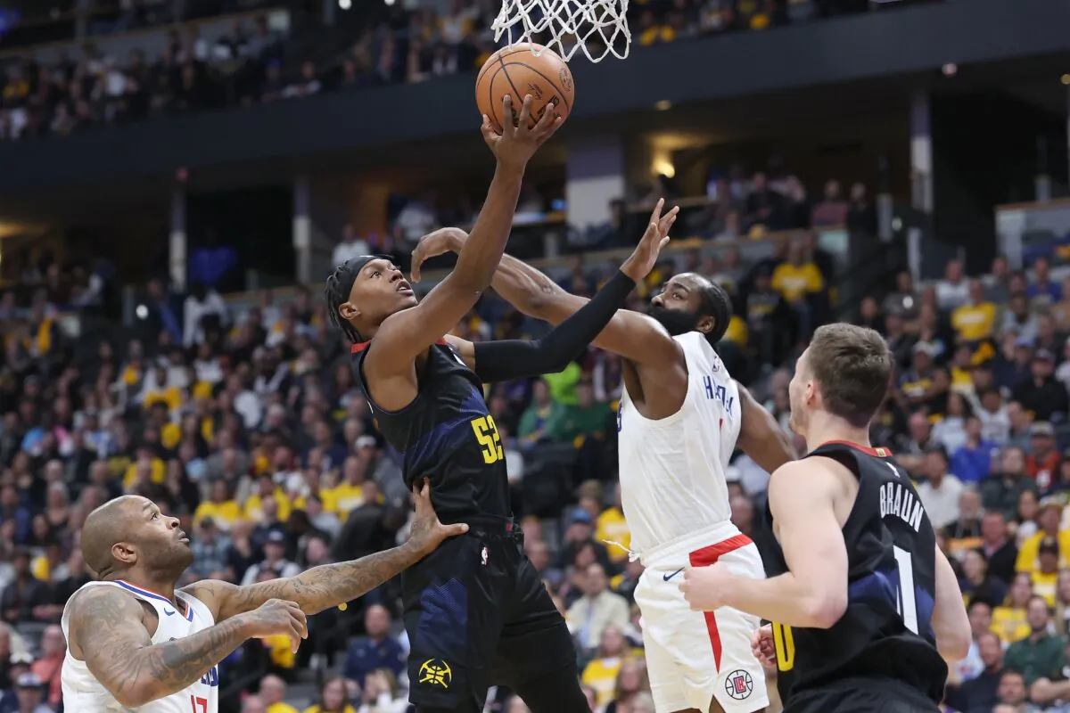 Peyton Watson (8) of the Denver Nuggets goes to the basket against James Harden (1) of the Los Angeles Clippers in the first quarter in Denver on Nov. 14, 2023. (Matthew Stockman/Getty Images)