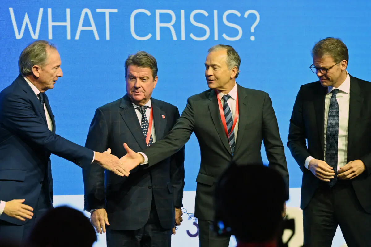 James Gorman (L), chairman and chief executive of Morgan Stanley, greets Bob Prince (2nd R), co-chief investment officer at Bridgewater Associates, as Colm Kelleher (2nd L), chairman of UBS Group and Christian Sewing (R), chief executive officer of Deutsche Bank AG, look on at the Global Financial Leaders' Investment Summit in Hong Kong on Nov. 7, 2023. (Peter Parks/ AFP via Getty Images)