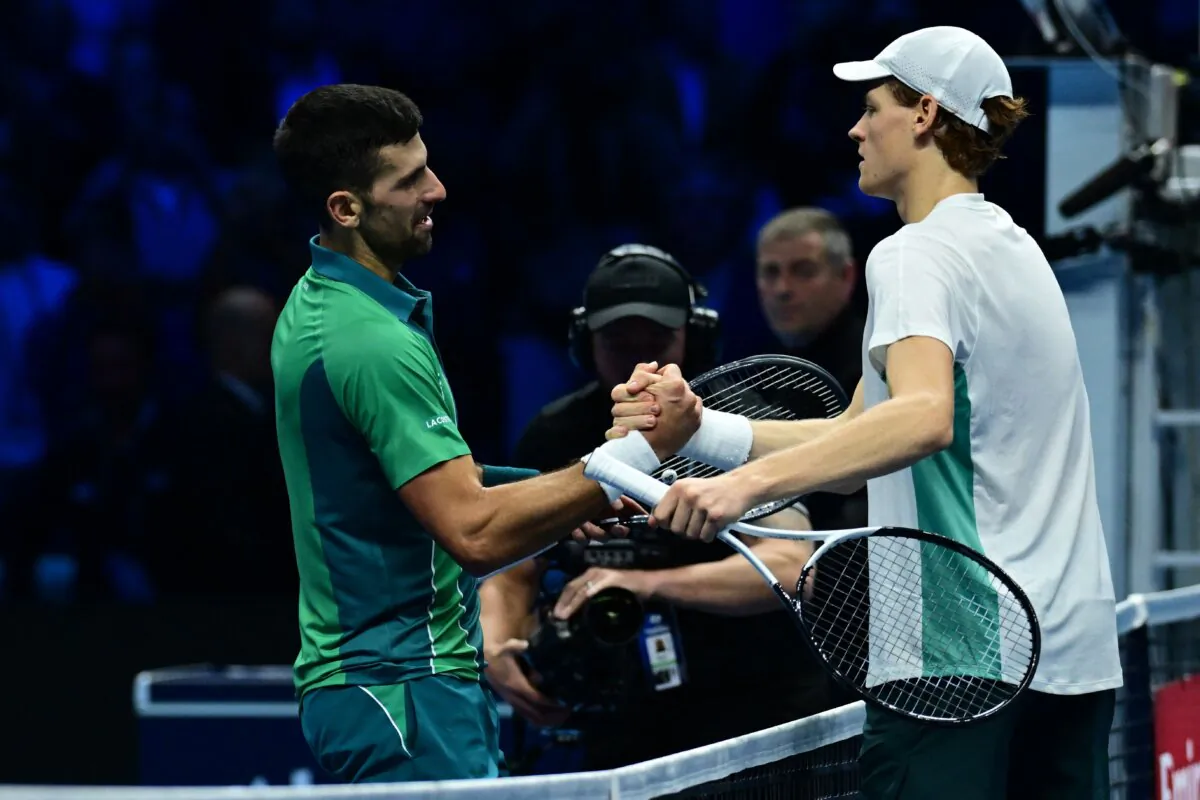 Serbia's Novak Djokovic (L) and Italy's Jannik Sinner shake hands after Sinner won their round-robin match against Serbia's Novak Djokovic on day 3 of the ATP Finals tennis tournament in Turin on Nov. 14, 2023. (Tiziana Fabi/AFP via Getty Images)