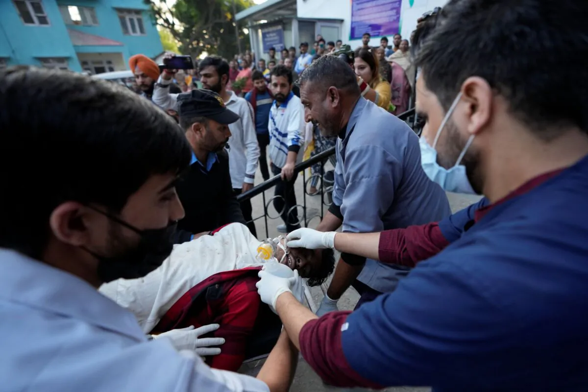 A man injured after a passenger bus slid off a Himalayan highway is brought for treatment at a government hospital in Jammu, India, on Nov. 15, 2023. (Channi Anand/AP)