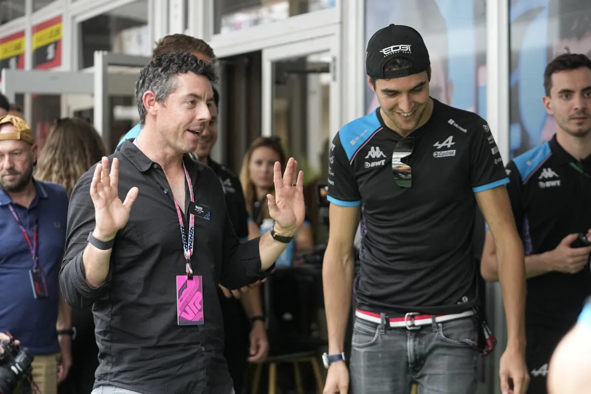 Rory McIlroy (L) of Northern Ireland, talks with Alpine driver Esteban Ocon, of France, before the sprint race ahead of the Formula One U.S. Grand Prix auto race at Circuit of the Americas in Austin, Texas, on Oct. 21, 2023. (Darron Cummings/AP Photo)