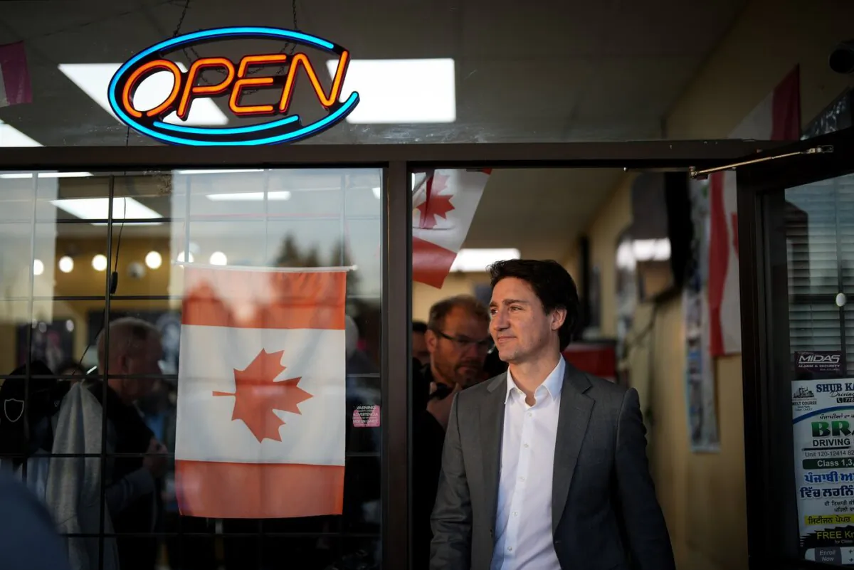 Prime Minister Justin Trudeau leaves a small business after stopping to meet the people inside, in Surrey, B.C., on Nov. 14, 2023. (The Canadian Press/Darryl Dyck)