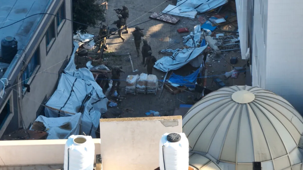 Israeli soldiers walk at the Al Shifa hospital complex in Gaza City, amid their ground operation against the Hamas terrorist group, in a still image from handout video obtained on Nov. 15, 2023. (Israeli Defence Forces/Handout via Reuters)