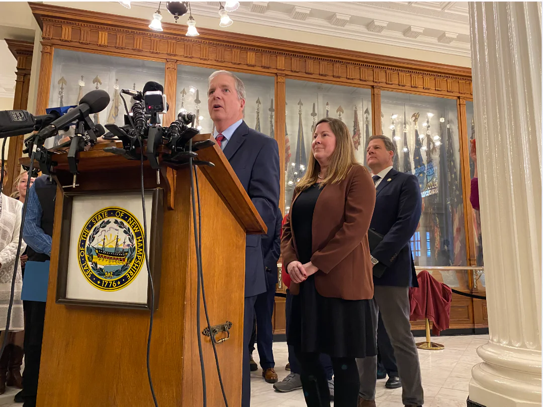 (L-R) New Hampshire Secretary of State David Scanlan speaks at a news conference with Deputy Secretary of State Erin Hennessey and New Hampshire Gov. Chris Sununu at the state Capitol in Concord, N.H., on Nov. 15, 2023. (Alice Giordano/The Epoch Times)