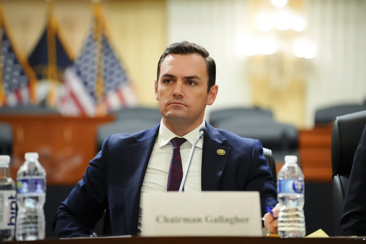 Chairman of the Select Committee on the Chinese Communist Party (CCP), Rep. Mike Gallagher (R-Wis.), watches a video during a press conference unveiling the results of the Committee’s investigation into the biolab discovered in Reedley, Calif., in Washington on Nov. 15, 2023. (Madalina Vasiliu/The Epoch Times)