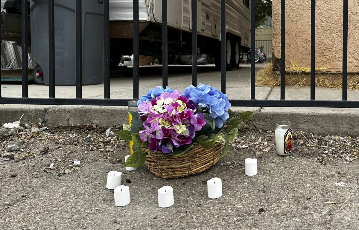 A makeshift memorial for a high school student lines a fence along an alleyway near Rancho High School in eastern Las Vegas on Nov. 15, 2023. (Rio Yamat/AP Photo)